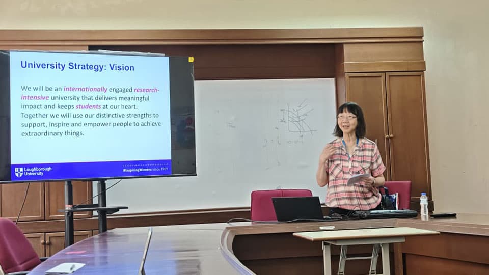 Professor Dr Phebe Mann the standing up in a lecture room in Malaysia. She has a presentation up on the board which reads University Strategy: Vision. We will be an internationally engaged research-intensive university that delivers meaningful impact and keeps students at our heart. The University logo is at the bottom on the presentation.